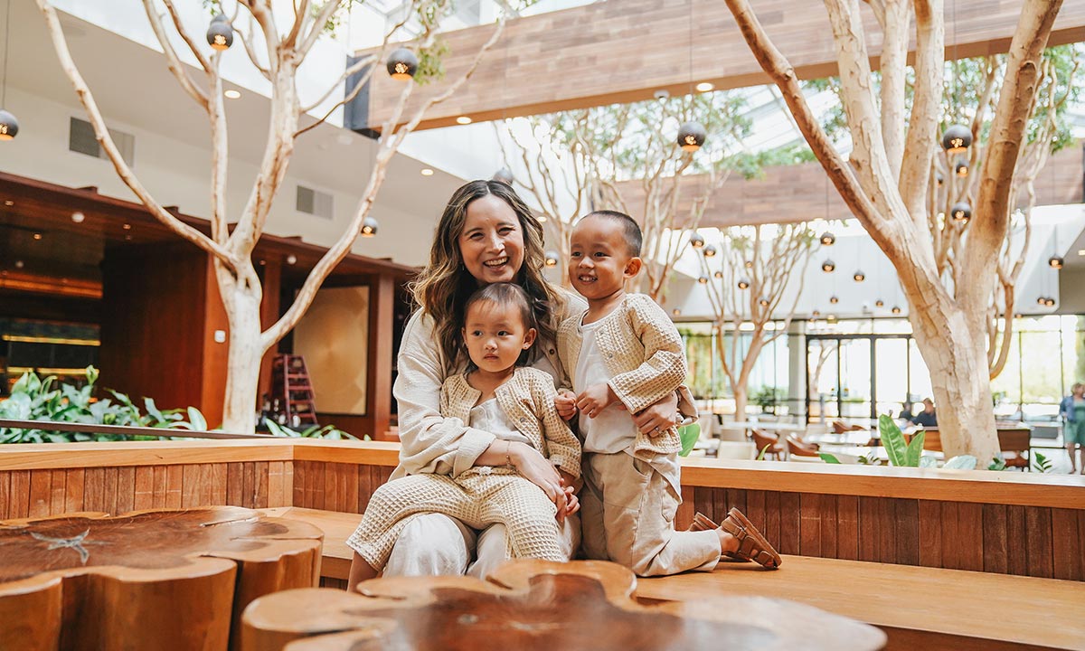 A family in the lobby smiling together.