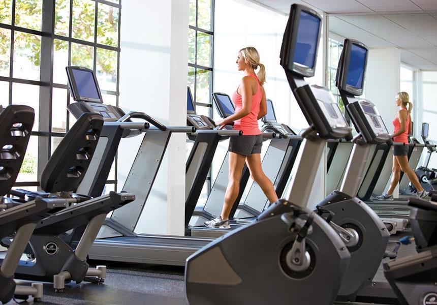 Woman using Fitness center.