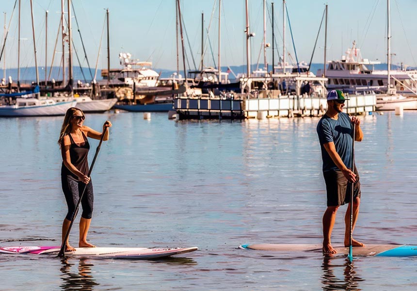 A couple paddle boarding.