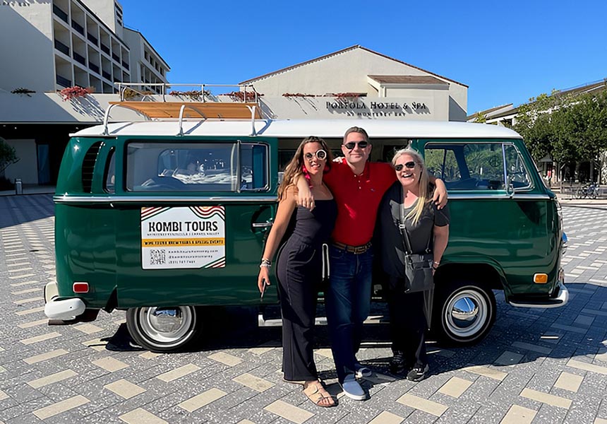 Group photo in front of a Vintage VW bus on a wine tour.