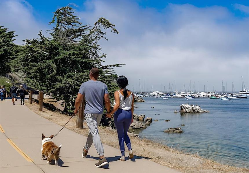 Couple walking their dog on the trail.