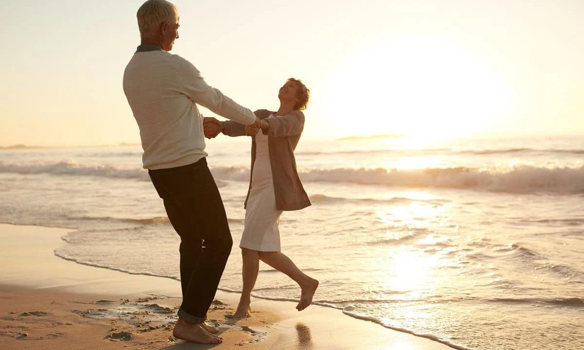 couple joining hands on the beach