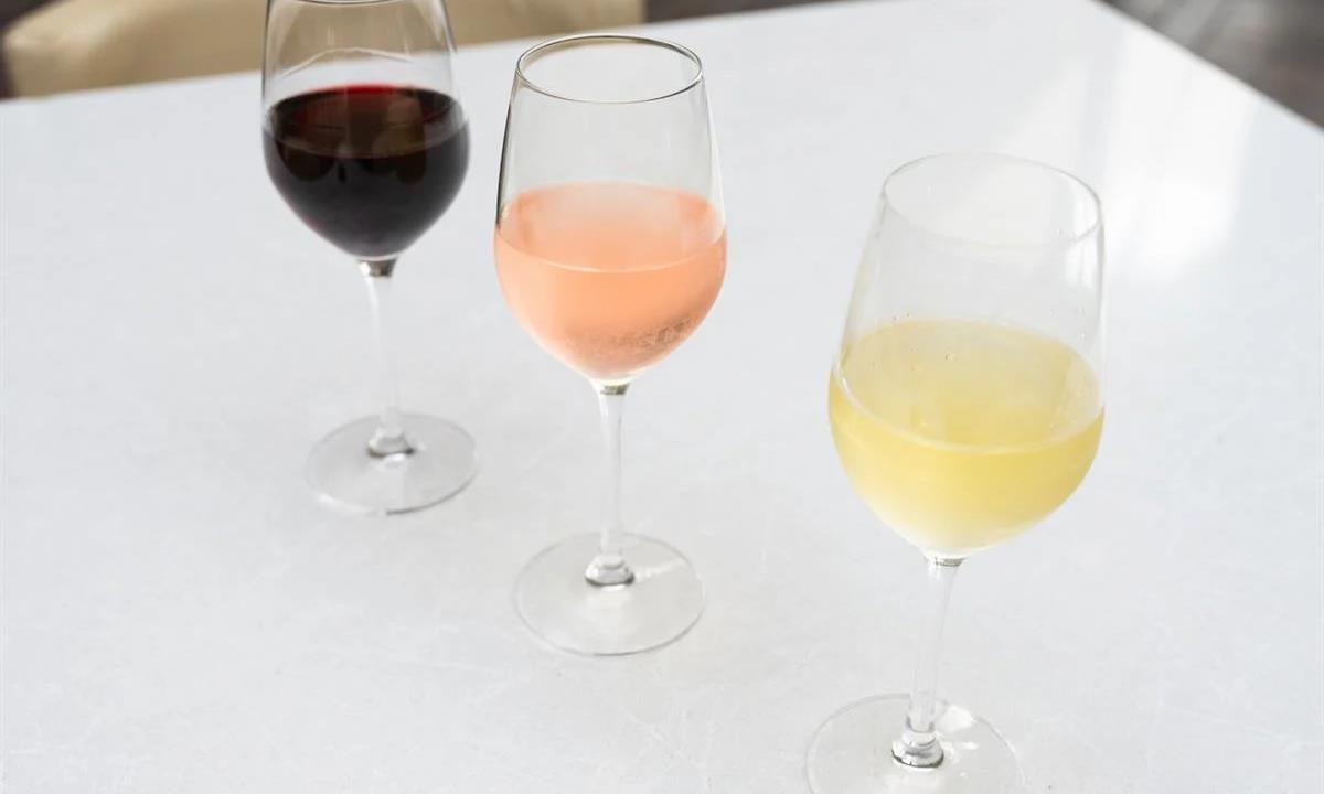 three wine glasses with different varieties of wine 