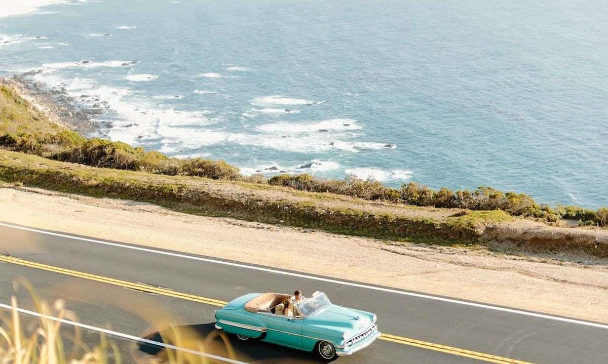 Driving car down coastline highway