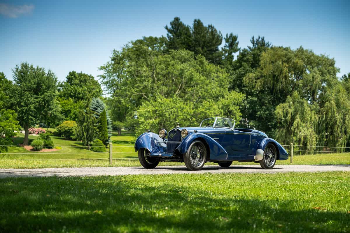 Classic car in front of the woods