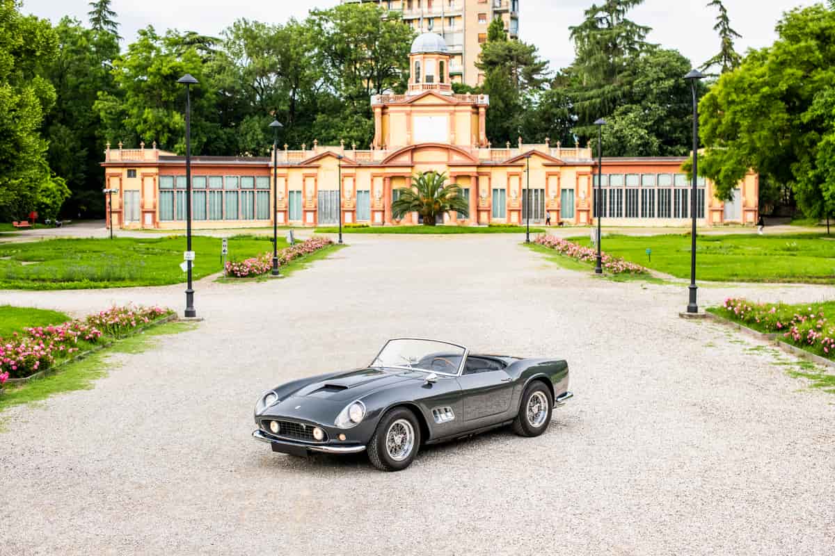 Classic car in front of estate