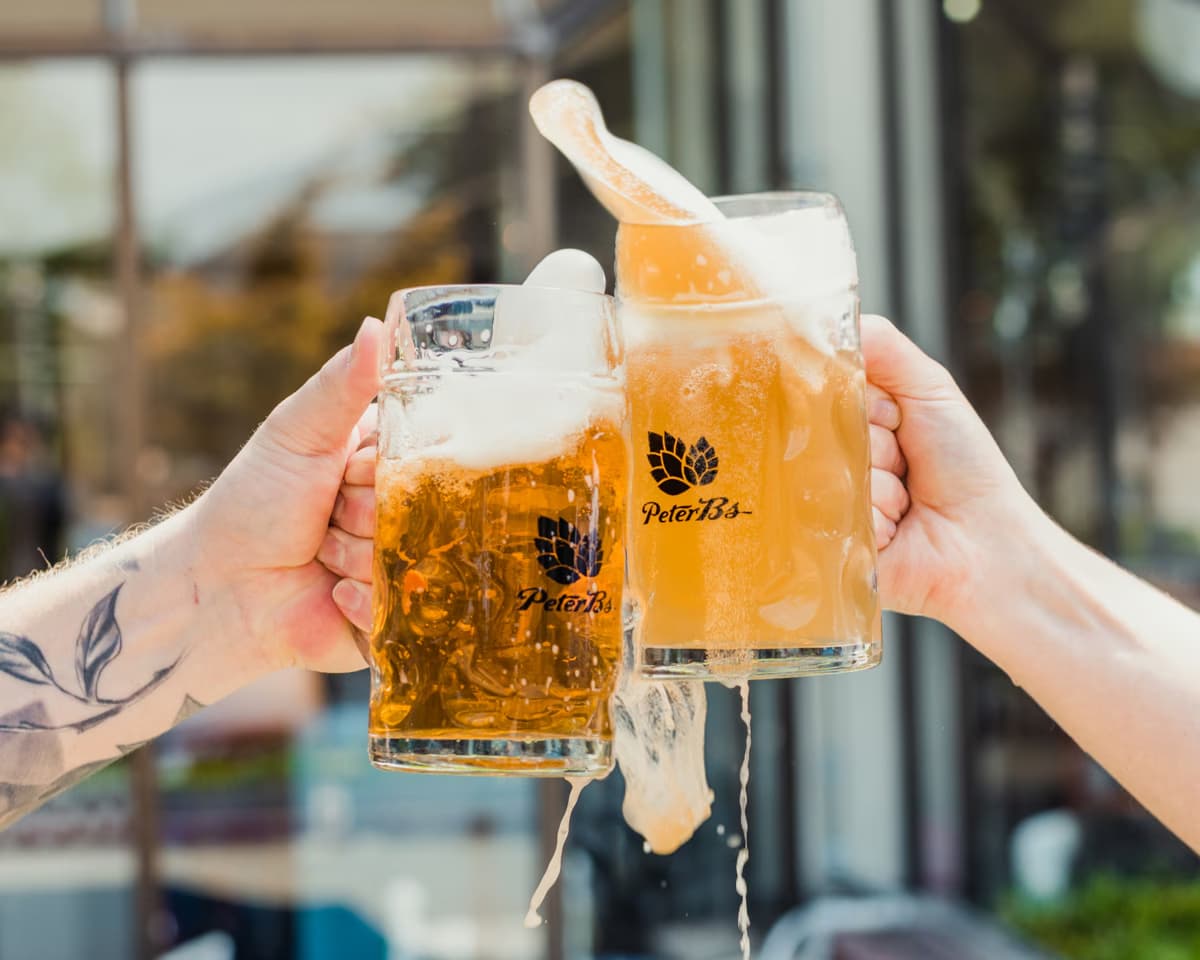 two people cheers with beers