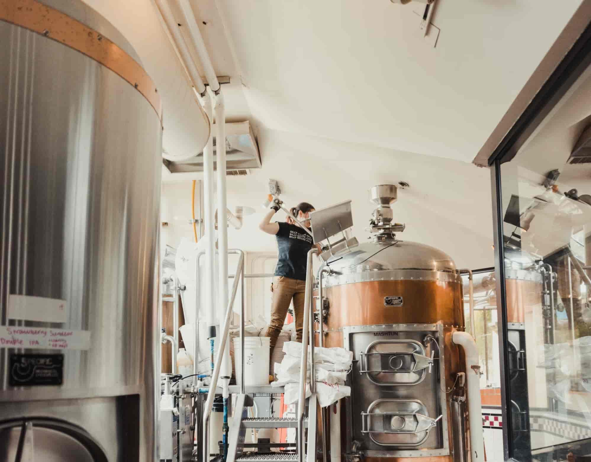 Woman checking beer silo
