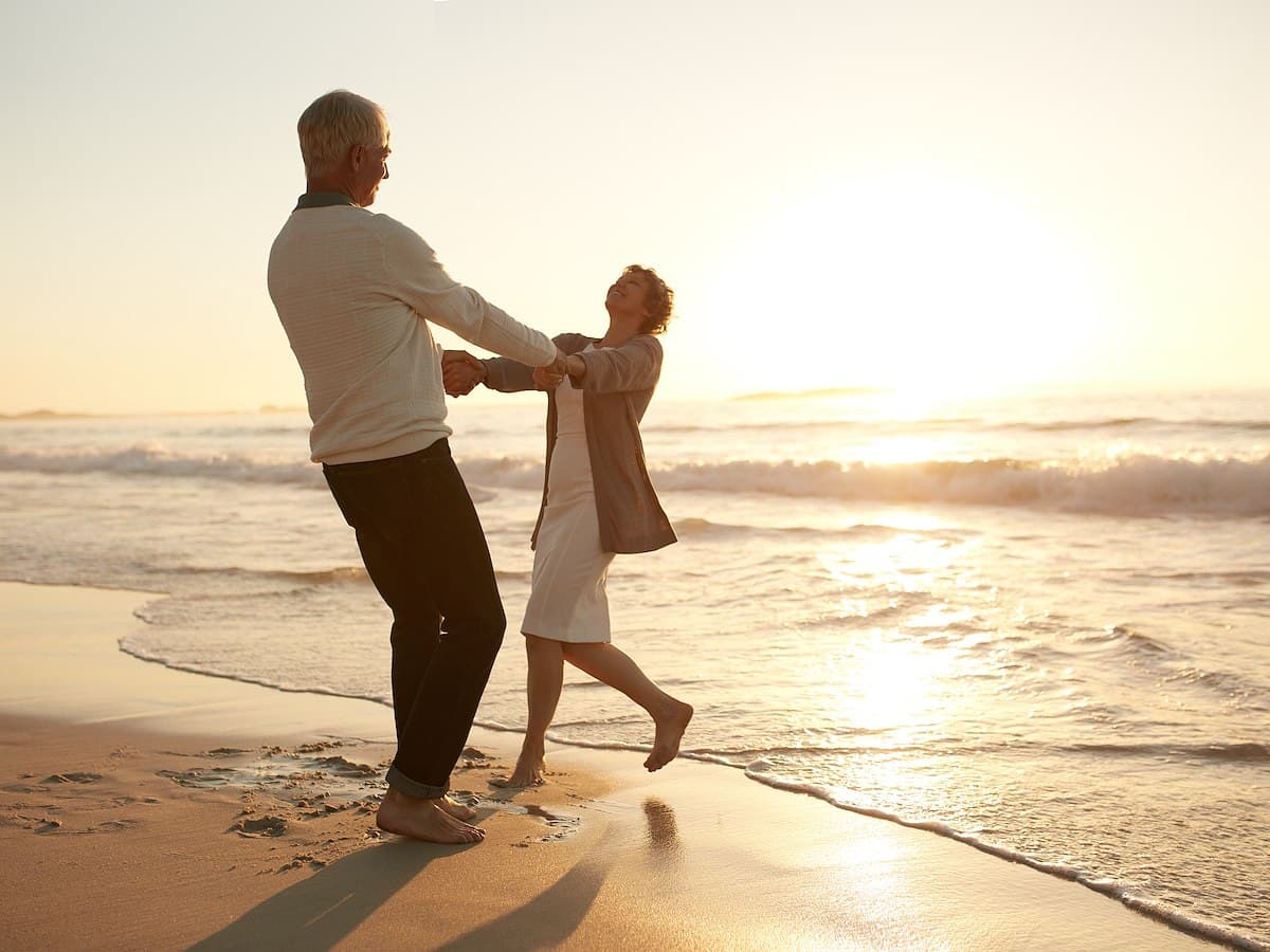 couple holding hands on the beach