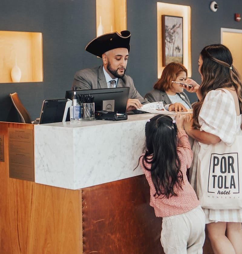 family at front desk 