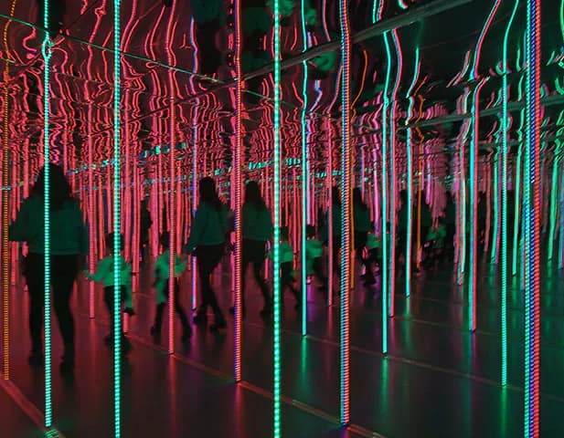 Mirror maze with people walking through