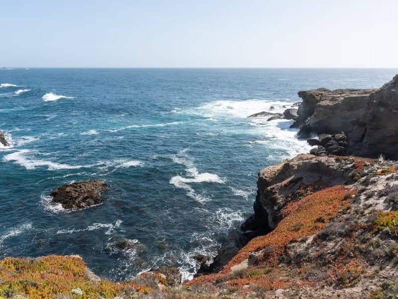 a cliffside view and ocean below