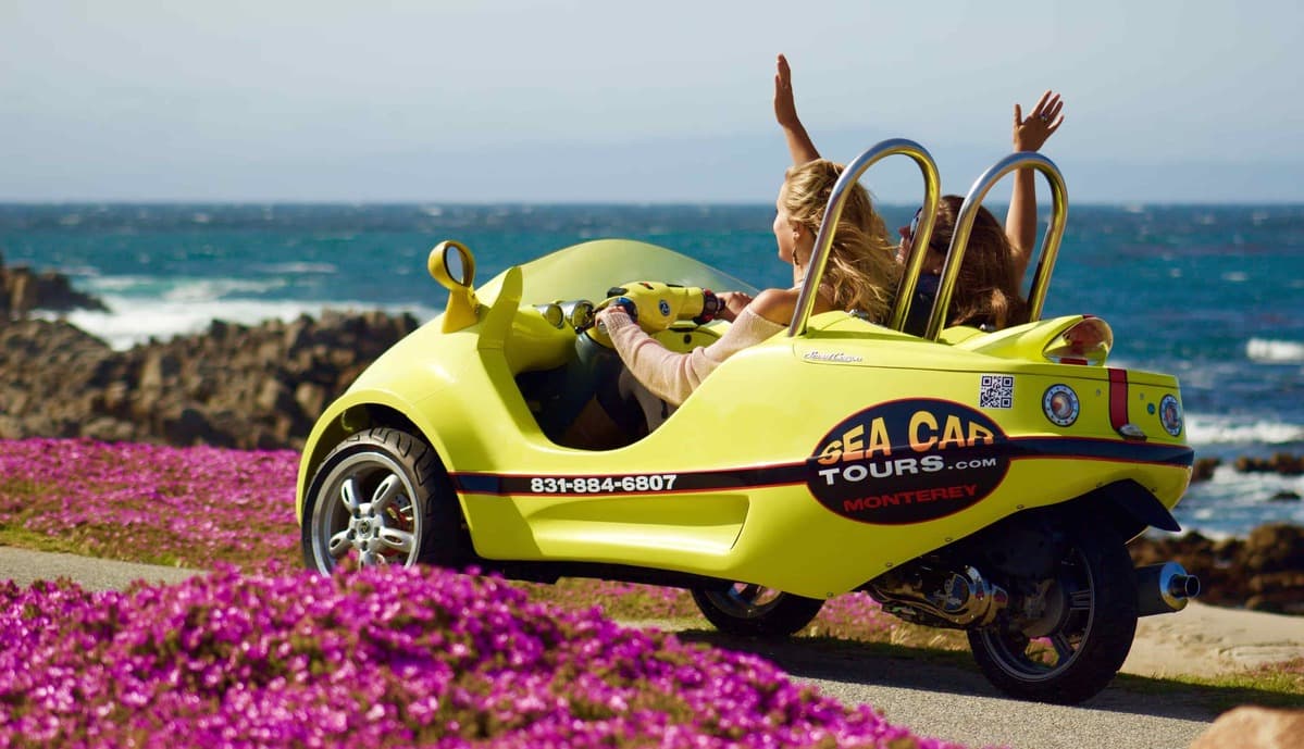 Two woman riding in small car