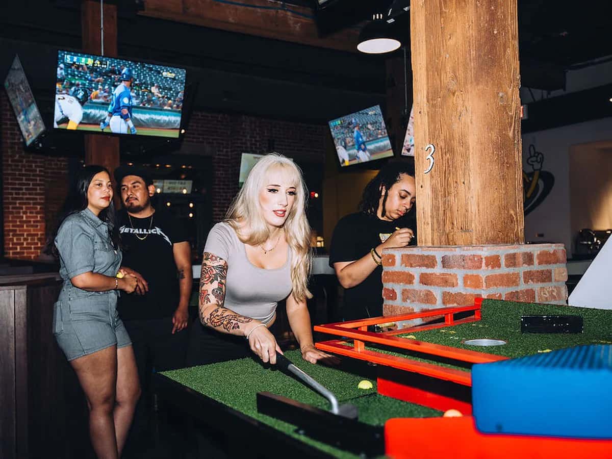 people playing putt putt in bar