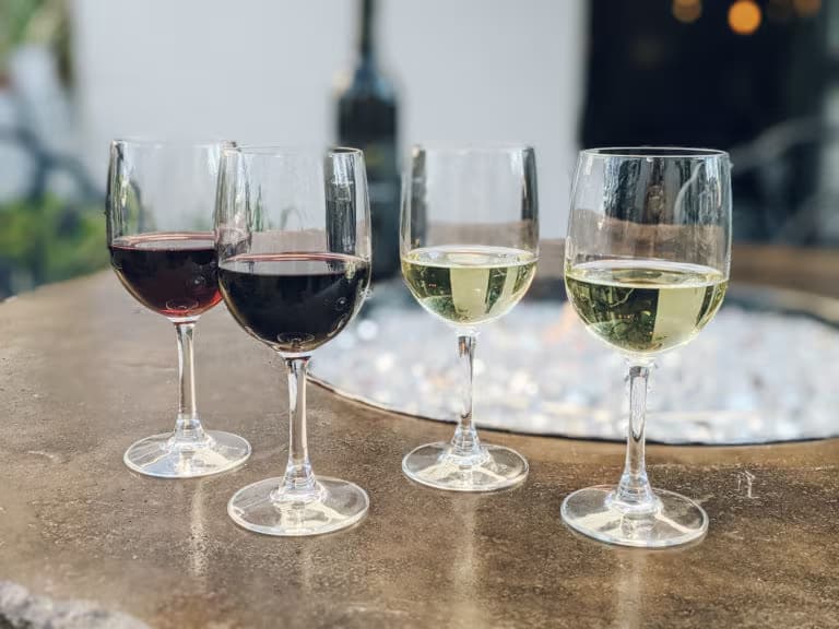 four wine glasses on table