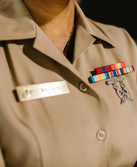 Employee in a beige buttoned shirt with pins