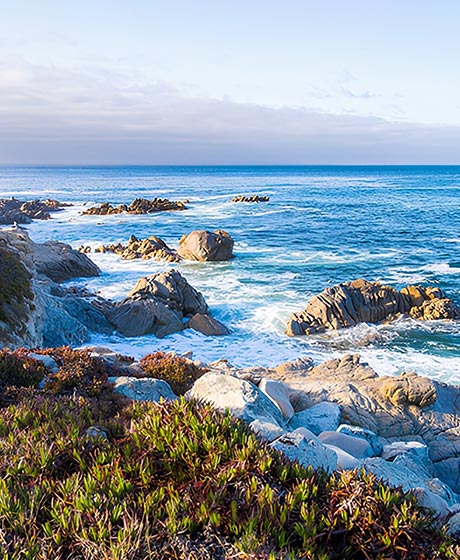 Cliffside view of waves crashing along some rocks