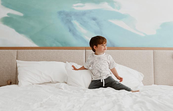 Child playing on guest bed.