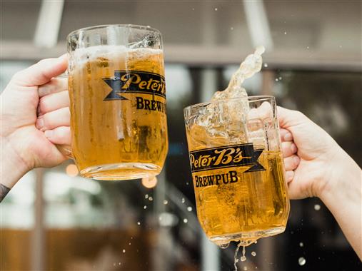 Two beer glasses hitting one another