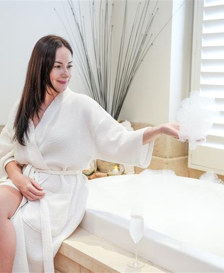 Woman by soaking tub
