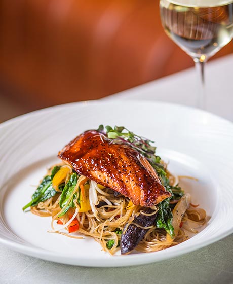Monterey Bay salmon dinner plate with wine.