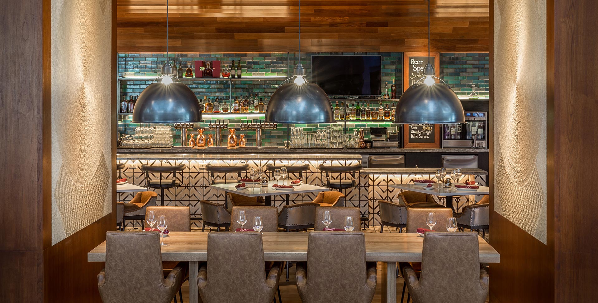 A dining area with a bar in the background